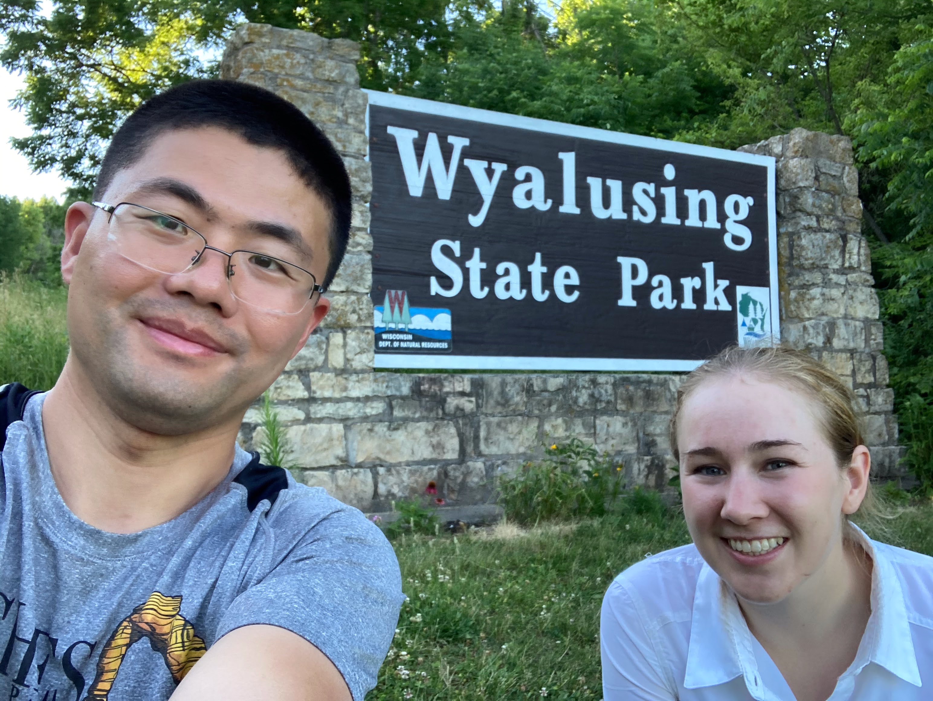 Kai Hu and Rachel at the entrance sign to Wyalusing State Park after a long day in the field.